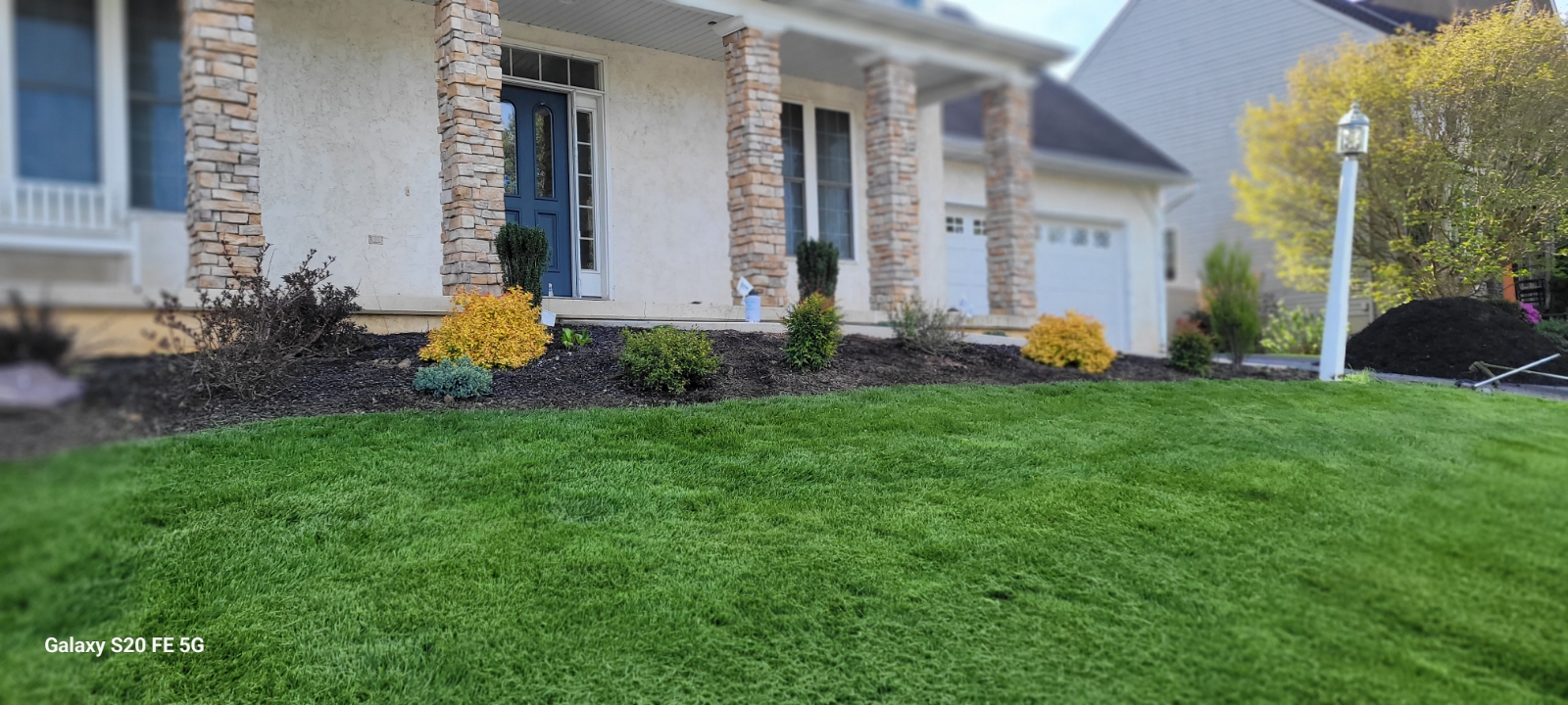 Cleaned garden in York PA with fresh mulch, no weeds, and large decorative rocks for visual appeal