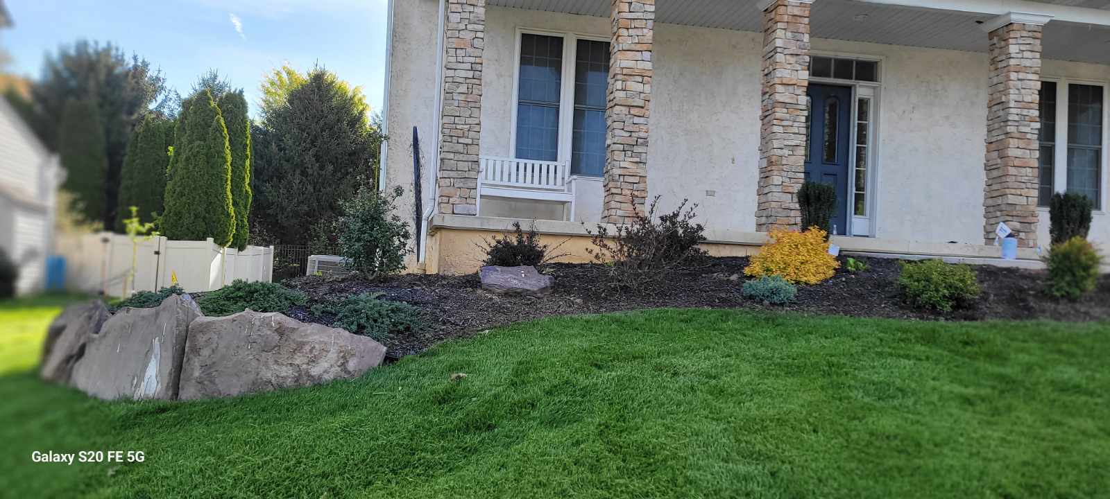 Cleaned garden in York PA with fresh mulch, no weeds, and large decorative rocks for visual appeal