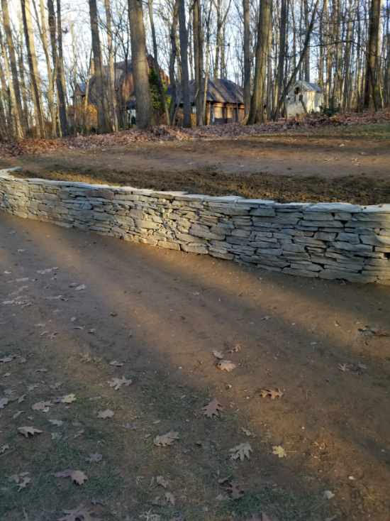 Newly built stone border in York PA used as a decorative guard in the landscaped yard